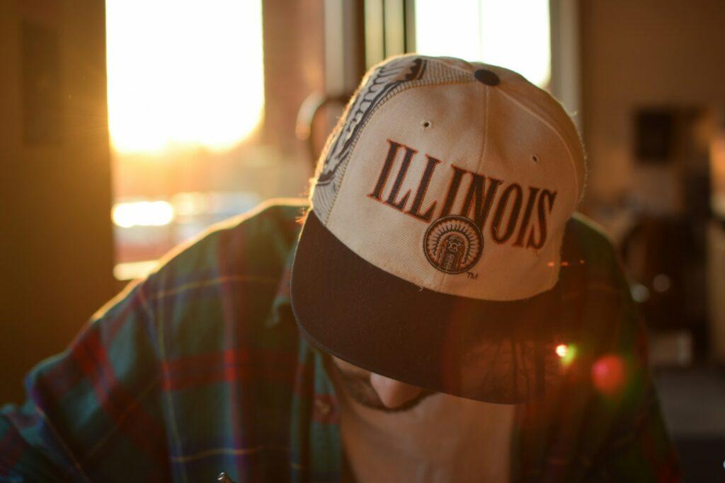 a person wearing a hat with illinois on it